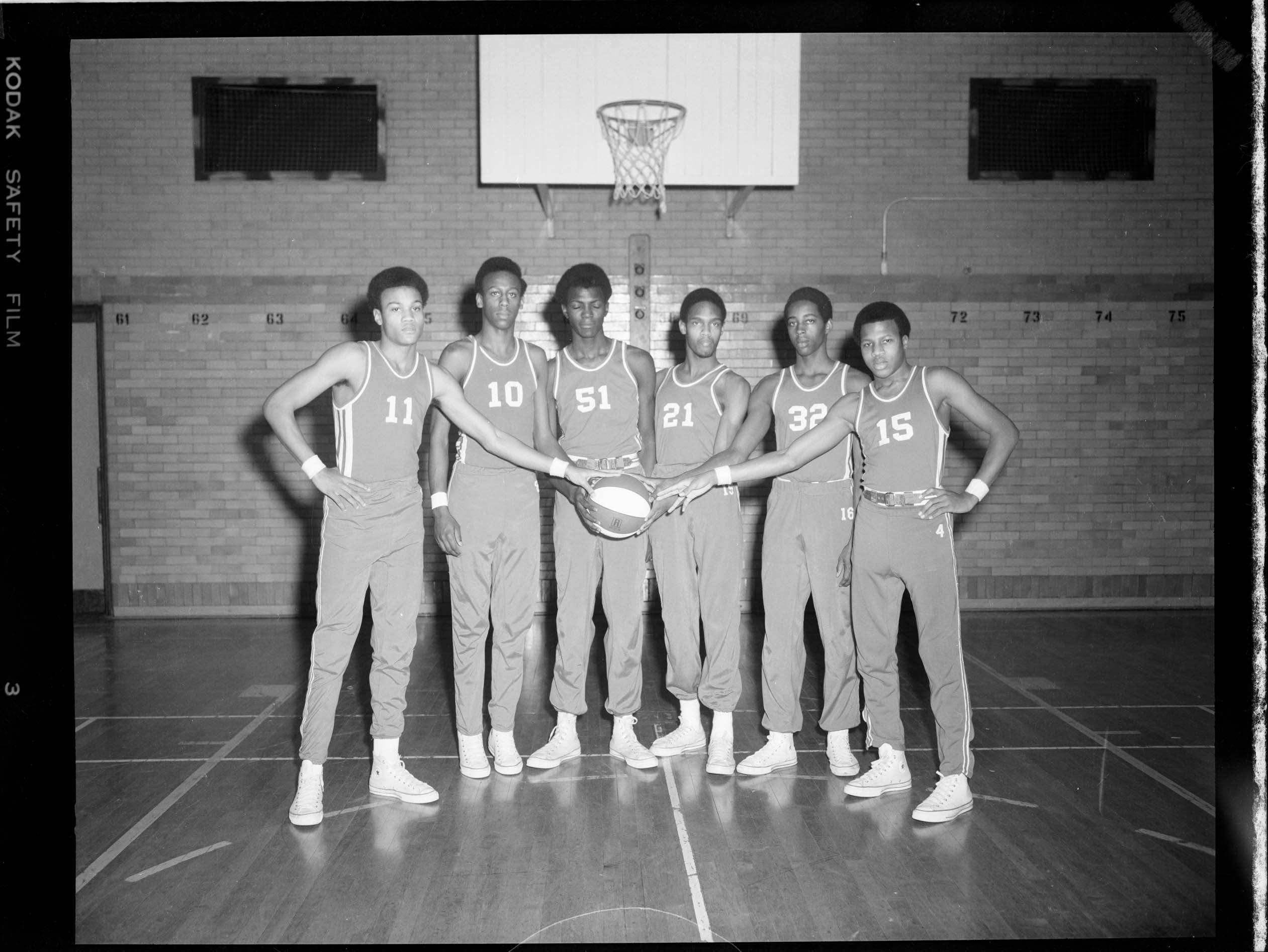 Group portrait of six Fifth Avenue High School basketball players, left
