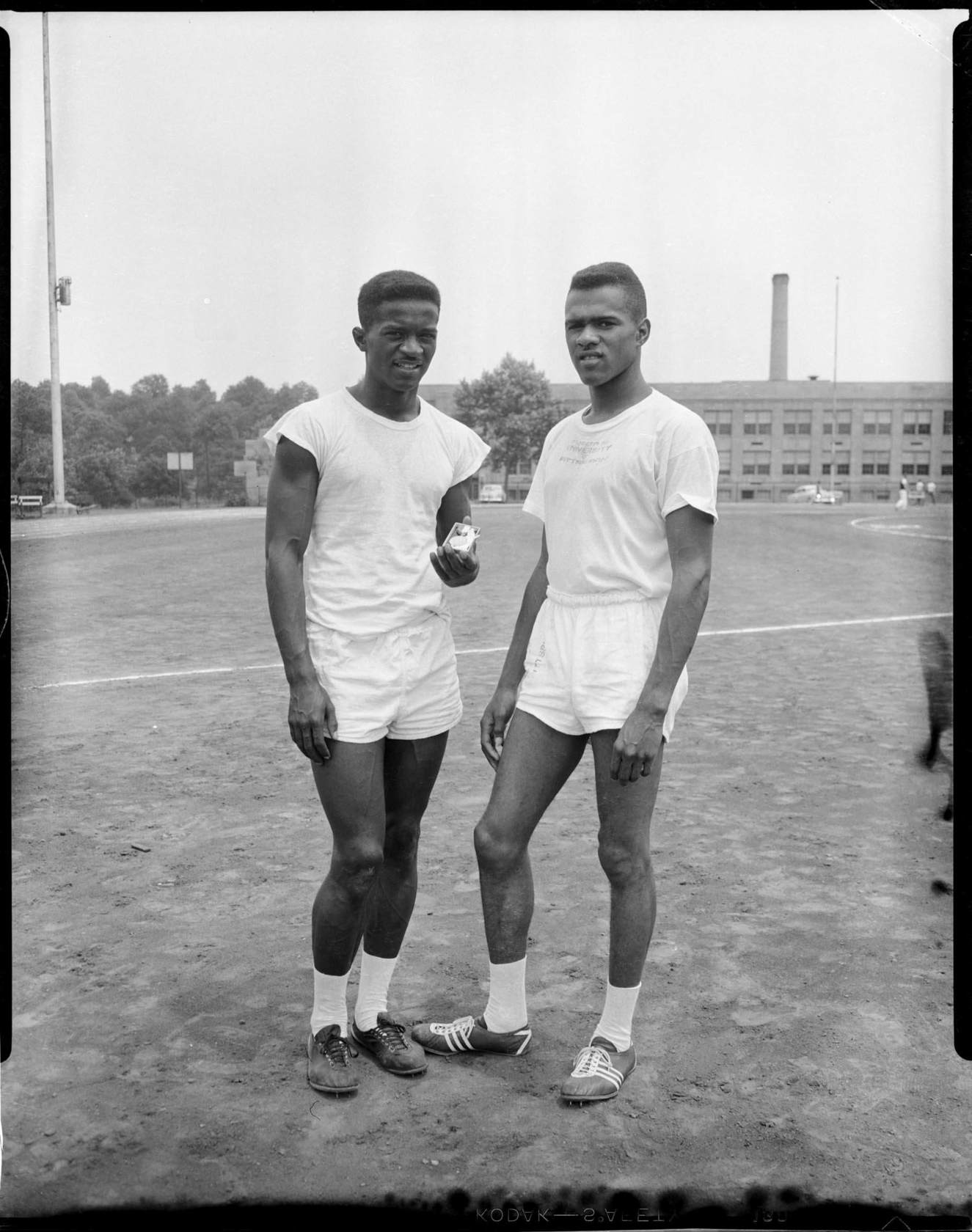 University of Pittsburgh track stars David Peays holding medal, and