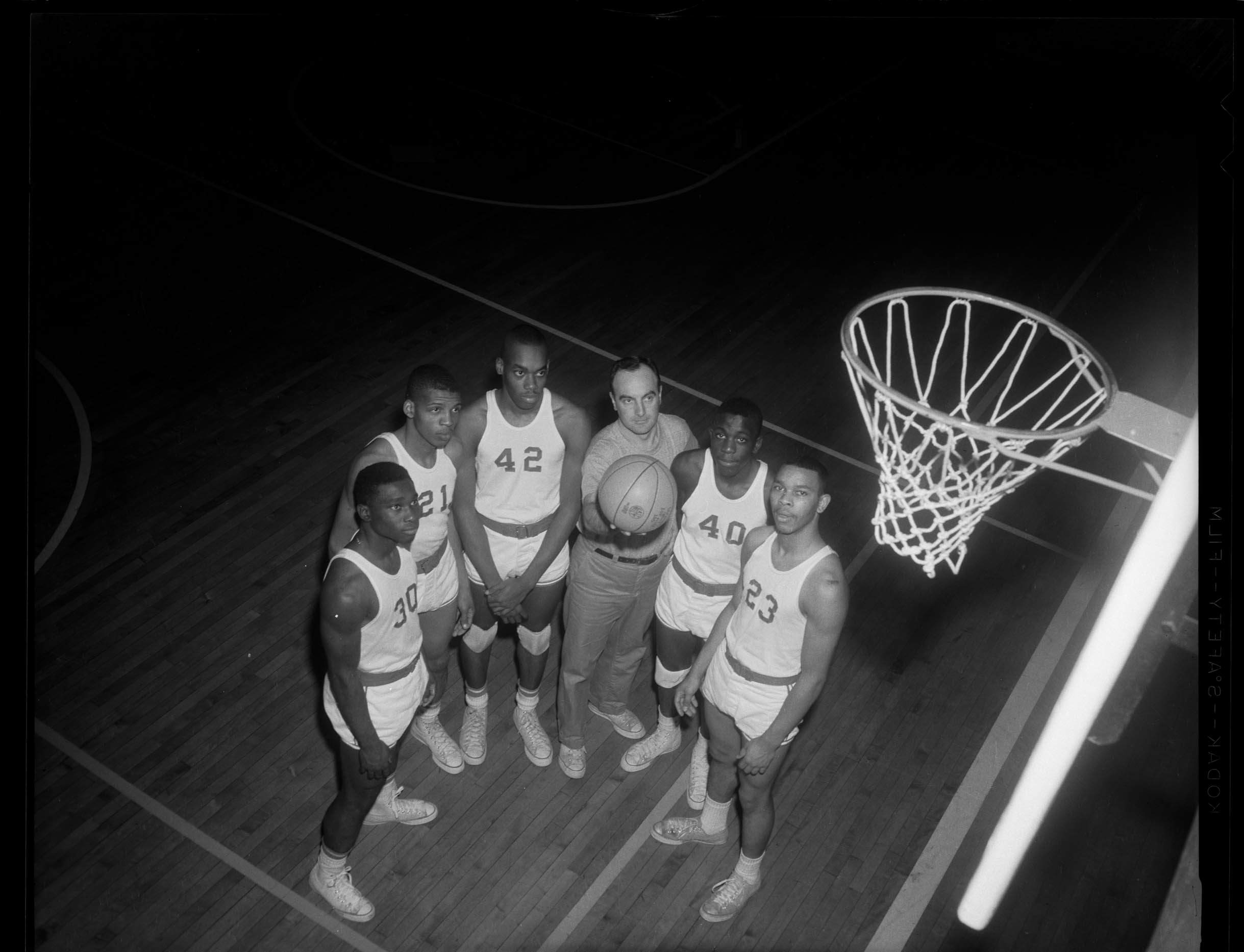 Group portrait of Fifth Avenue High School basketball team, including