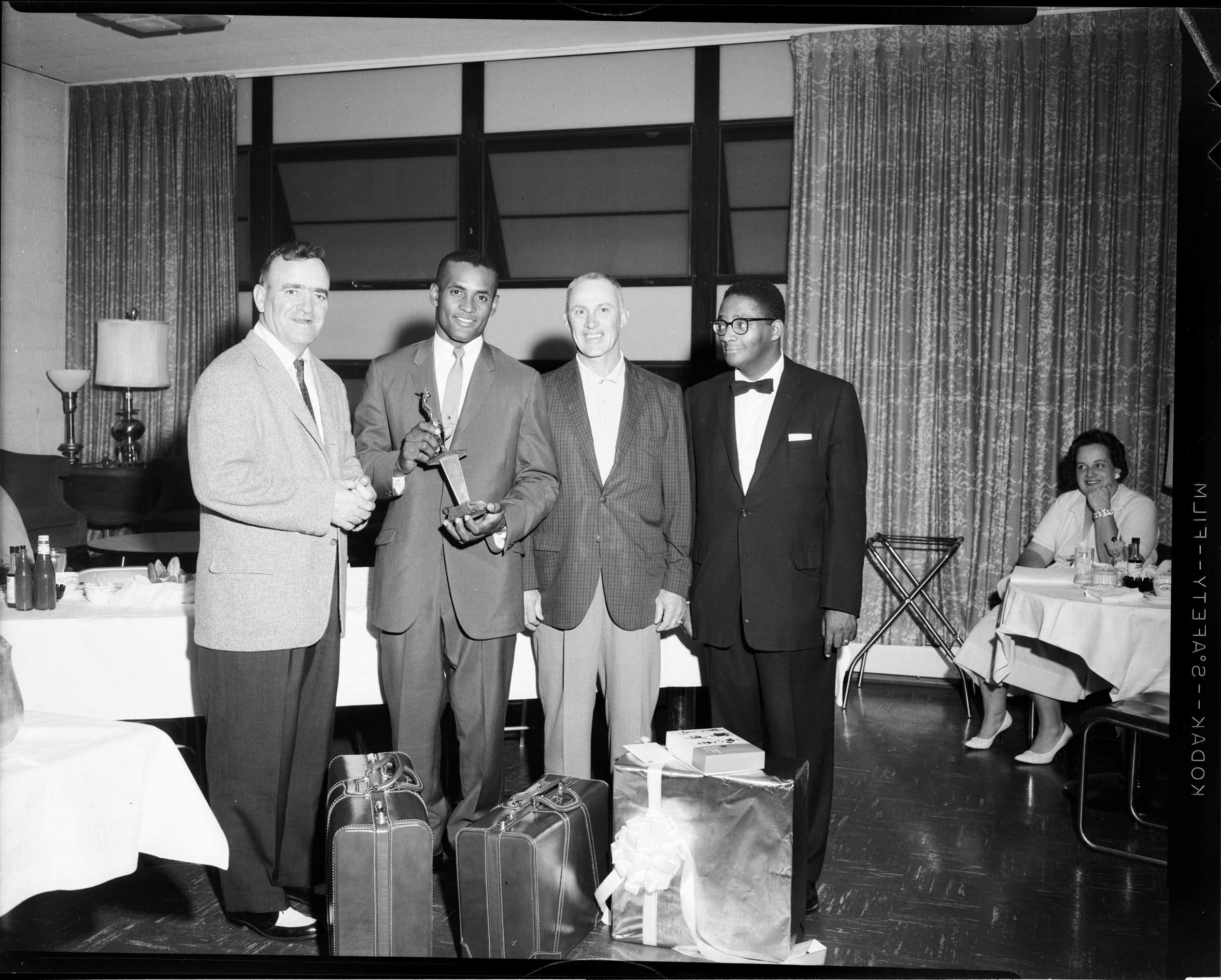 Four men, including Pittsburgh Pirates manager Danny Murtaugh, and baseball player Roberto