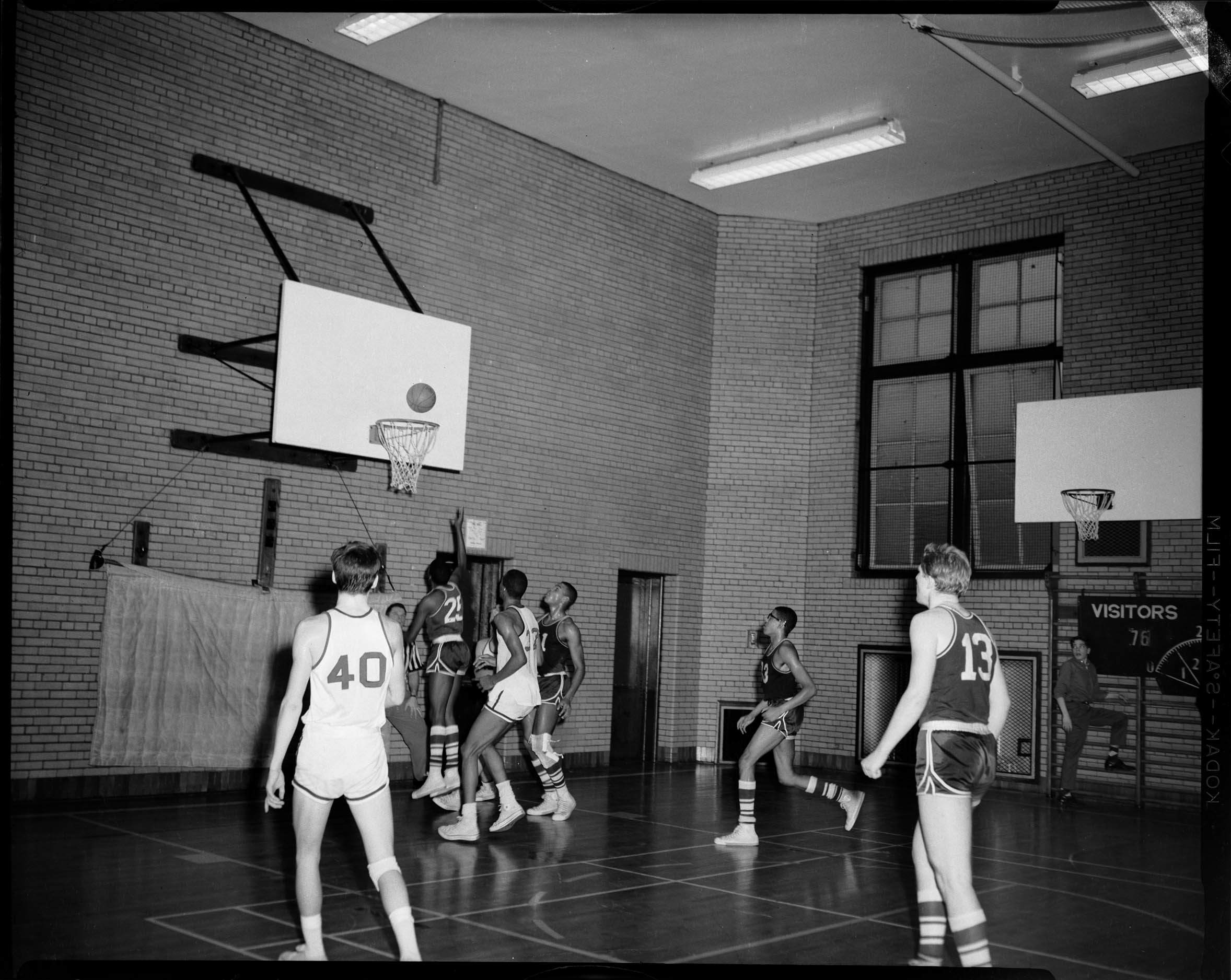 Basketball game, player shooting layup, in gym CMOA Collection