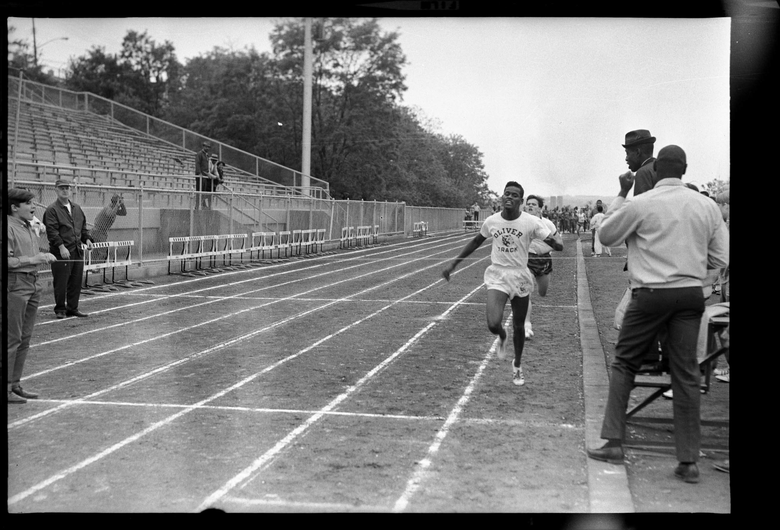 Oliver track team athelete approaching finish line CMOA Collection