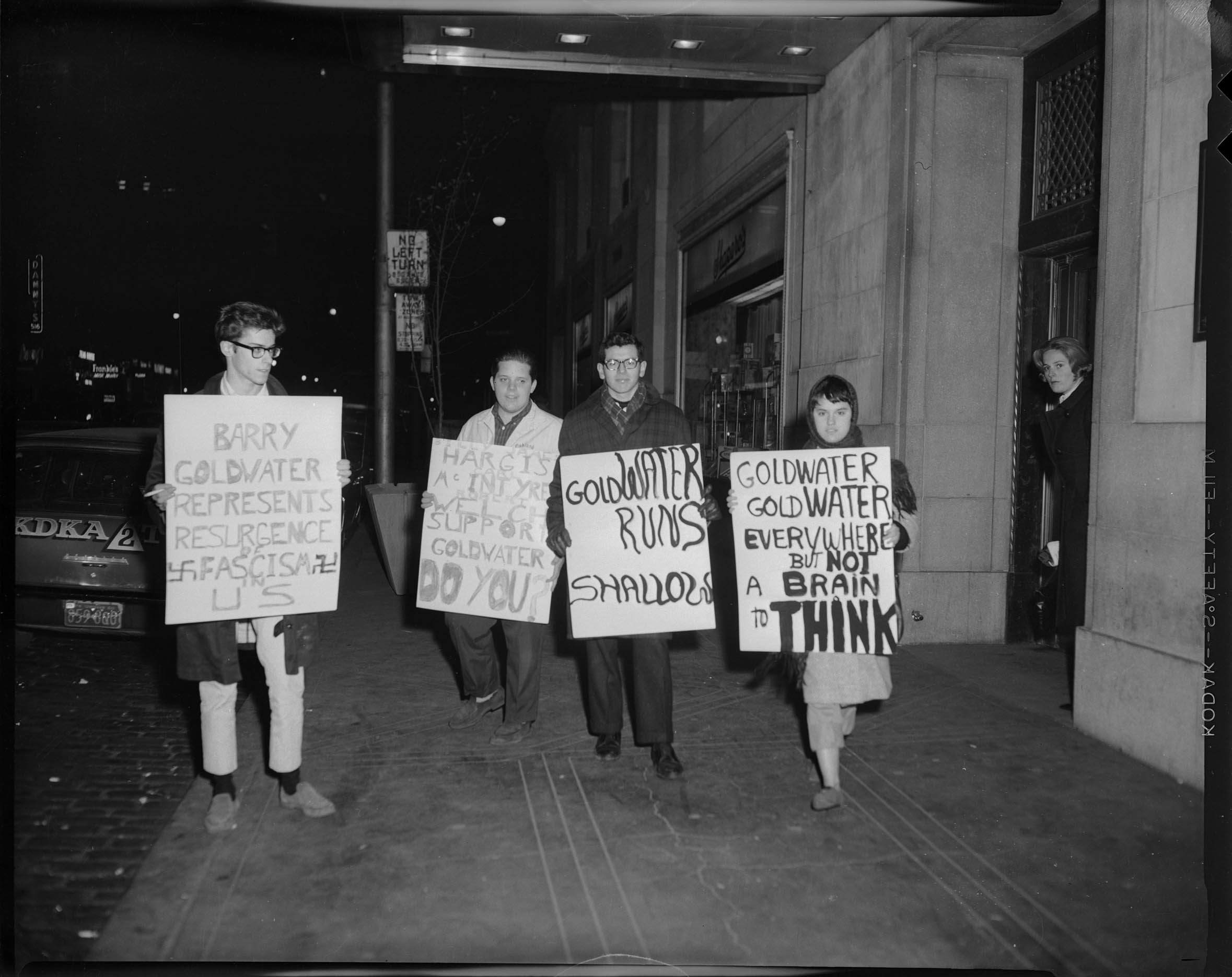 Protestors holding signs reading “Barry Goldwater represents resurgence of Fascism...