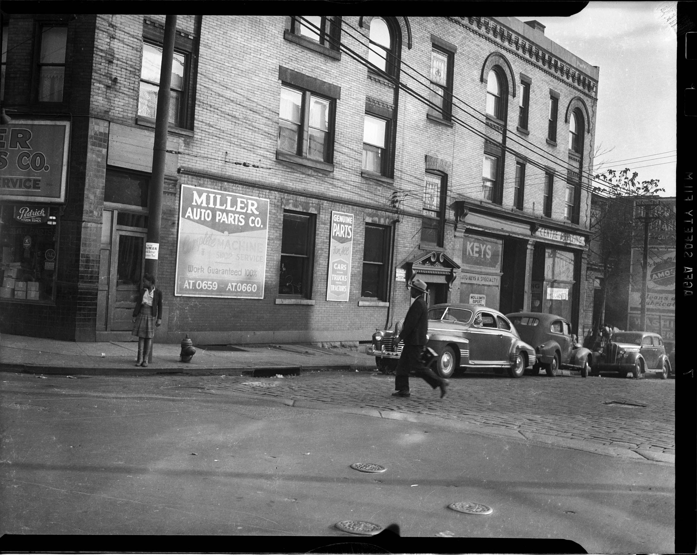 View of Miller Auto Parts Co. with sign in window for Pedrick Piston