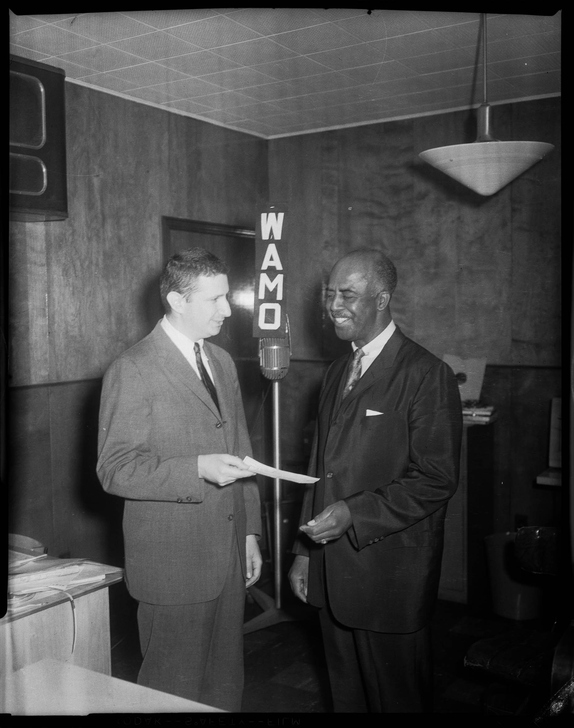 WAMO manager John Walk, and another man, speaking into WAMO radio