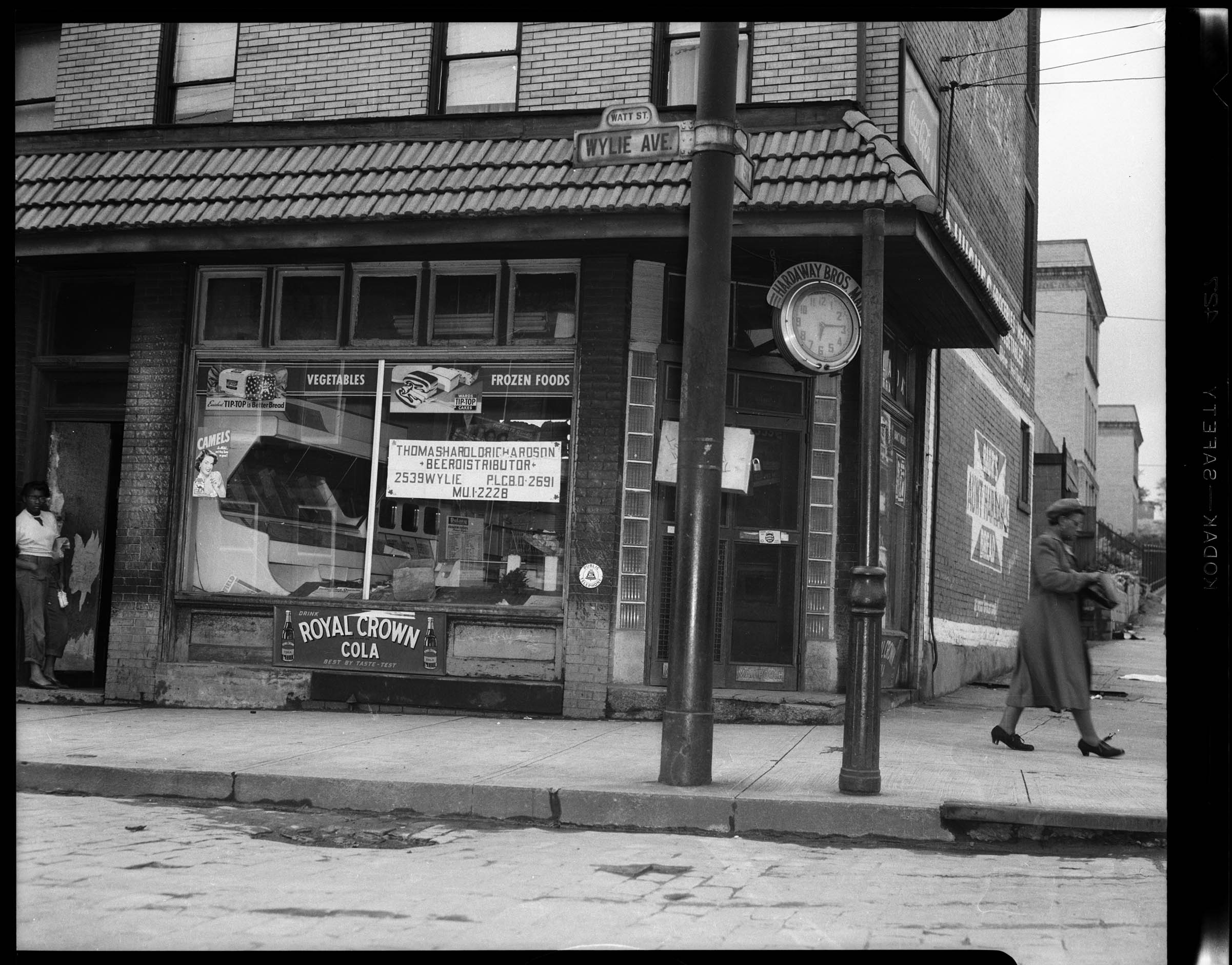 Corner store at Wylie Avenue and Watt Street, with sign in window