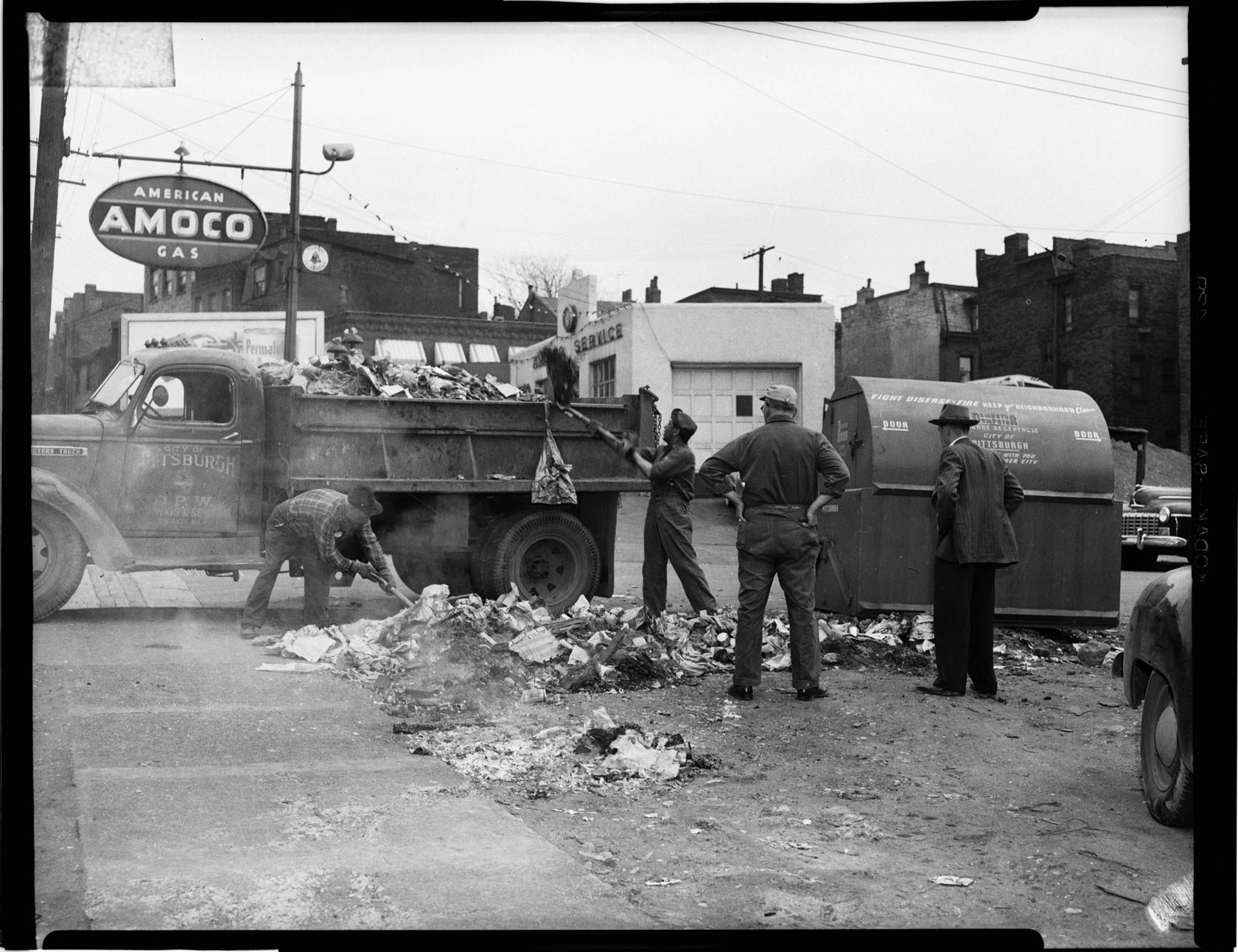 City of Pittsburgh Highways and Sewers crew shoveling garbage into