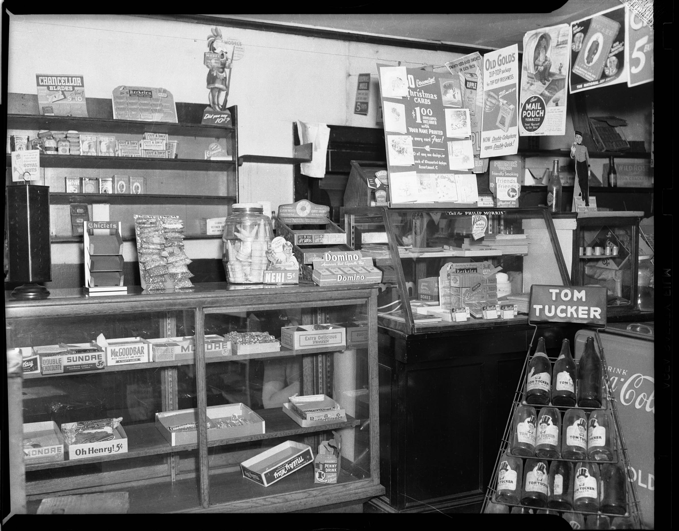 Interior of candy and tobacco store, with display of Tom Tucker ginger