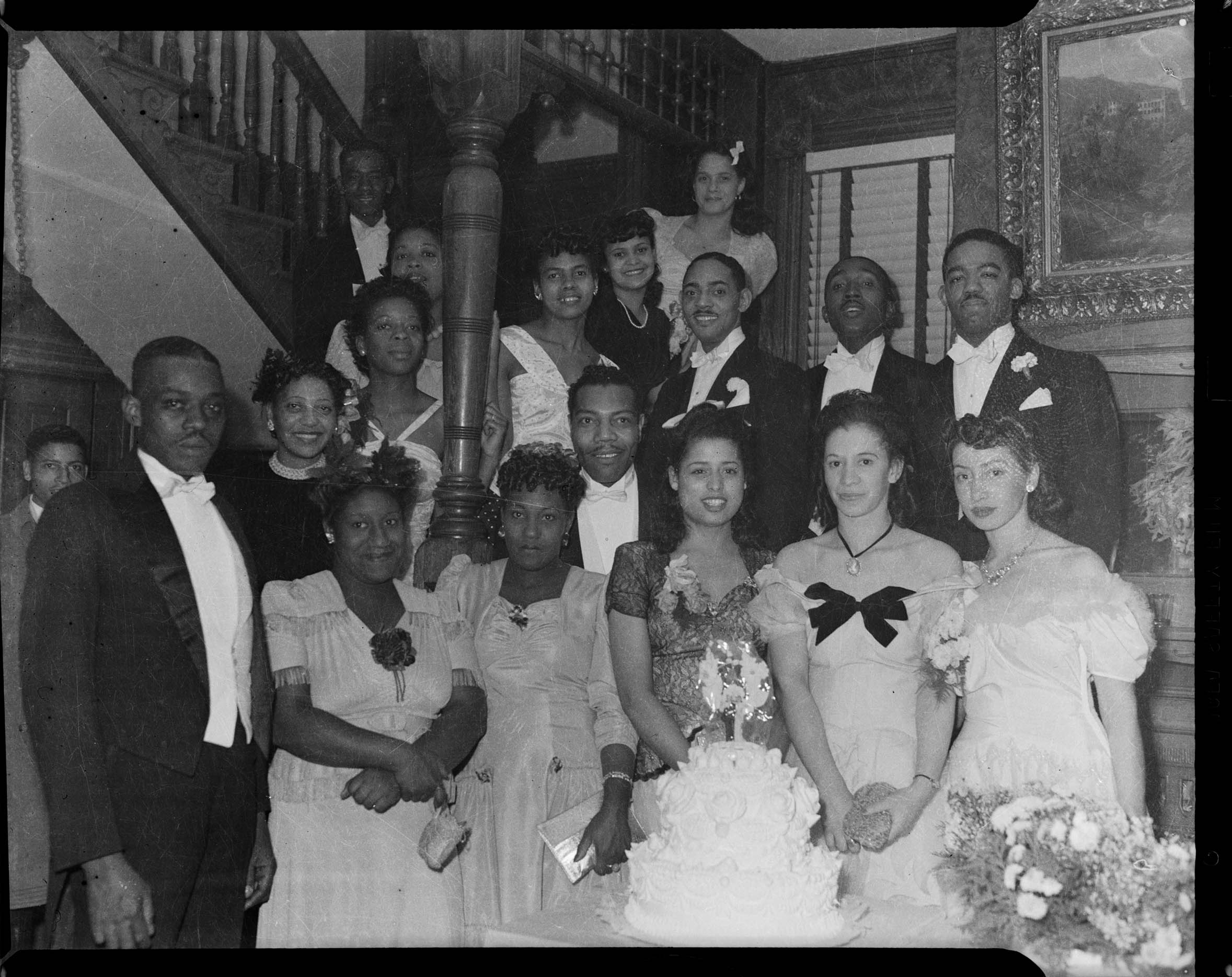 Men And Women In Formal Wear Including Woman Second From Right Wearing