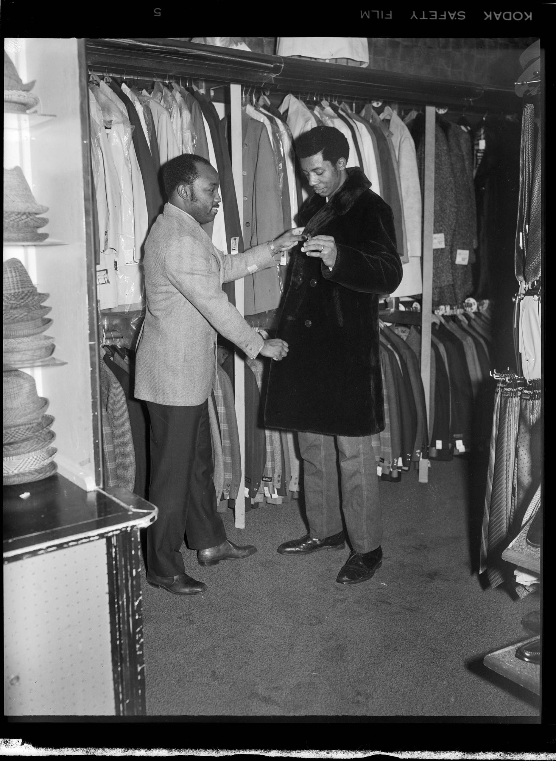 Richard or Curtis wearing wool suit jacket and moustache, assisting