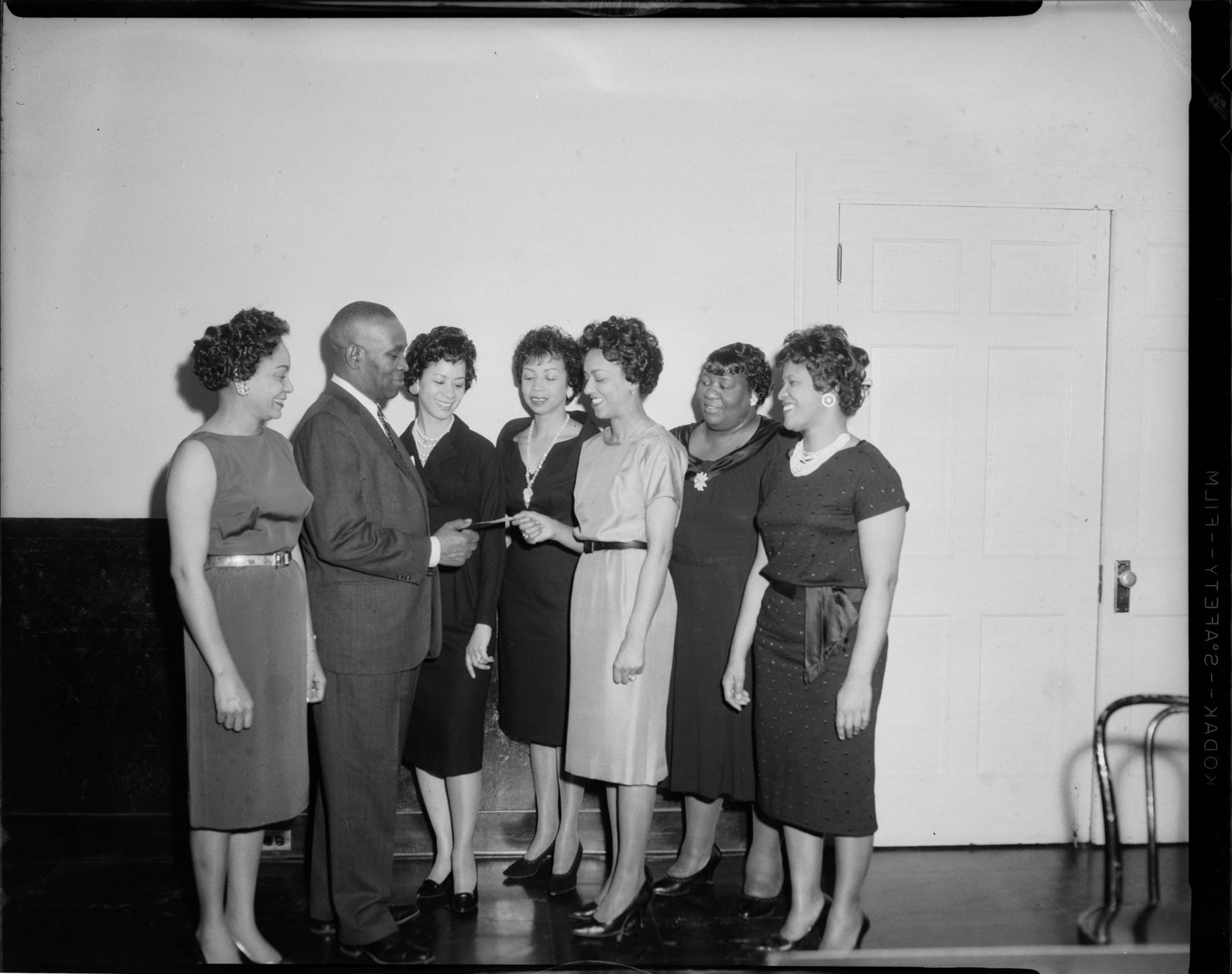 Six women and a man, members of the Debonnaires, left to right Emma