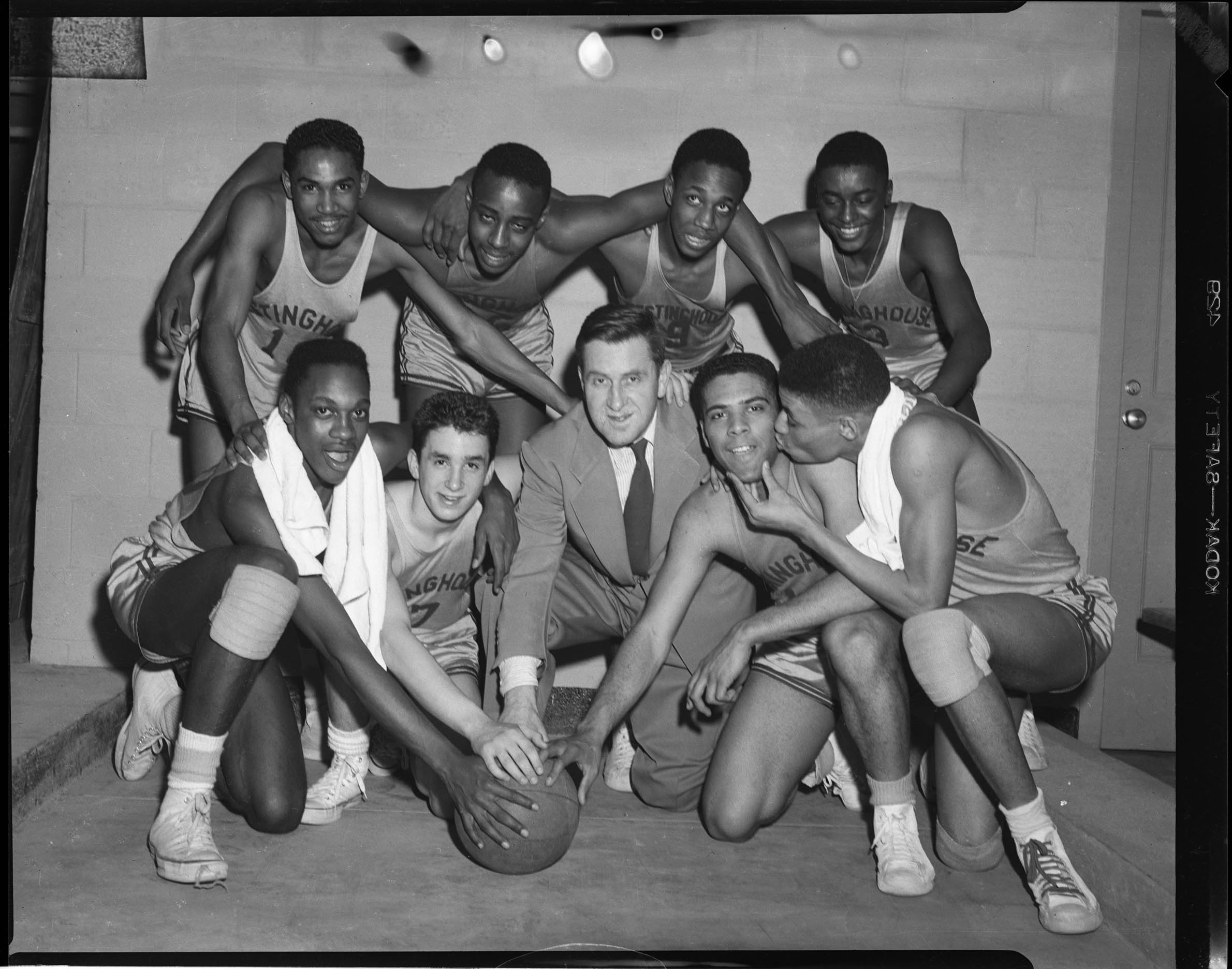 Group portrait of Westinghouse High School basketball team, including