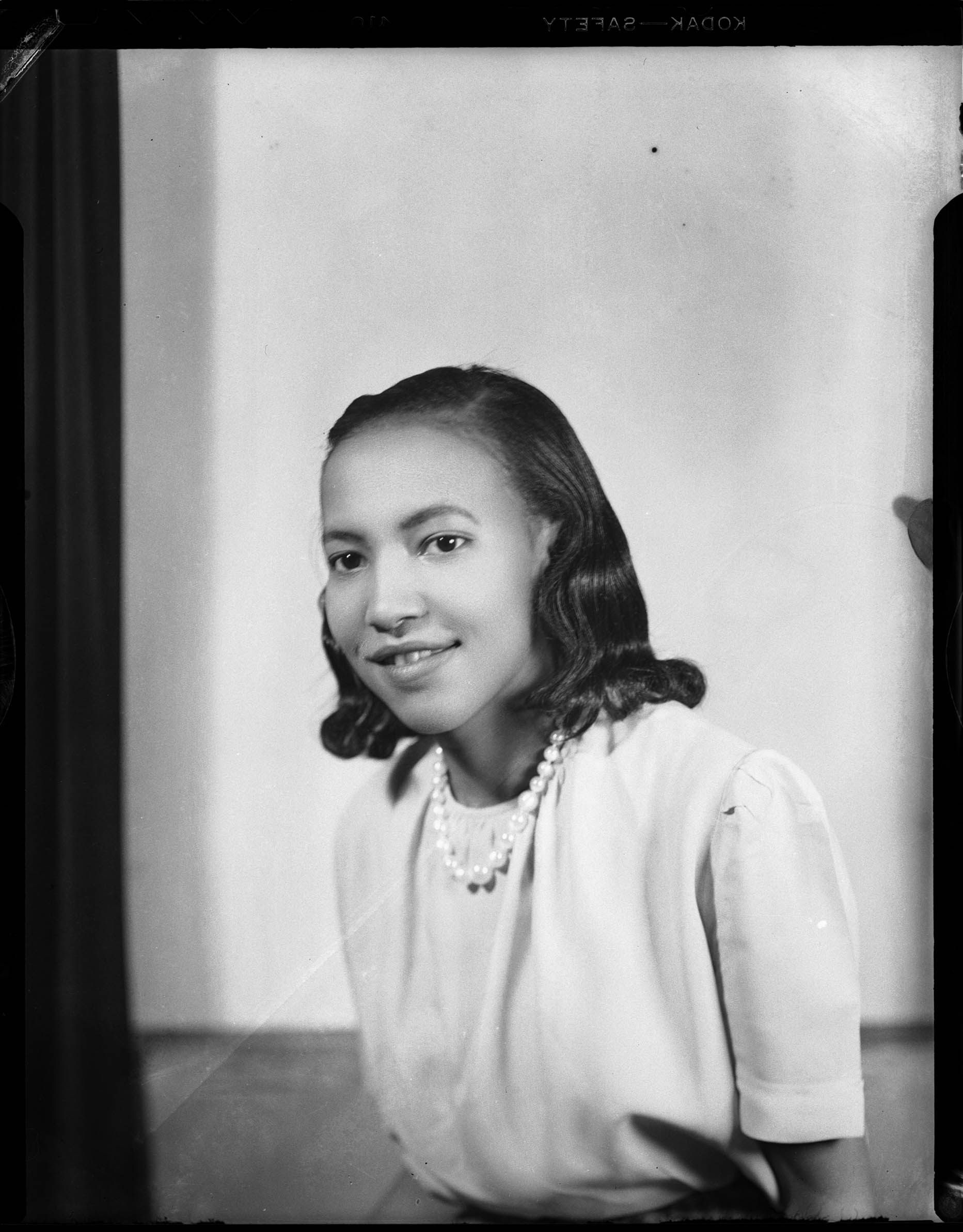 Portrait of woman, possibly Bernice Atkins, wearing light colored short