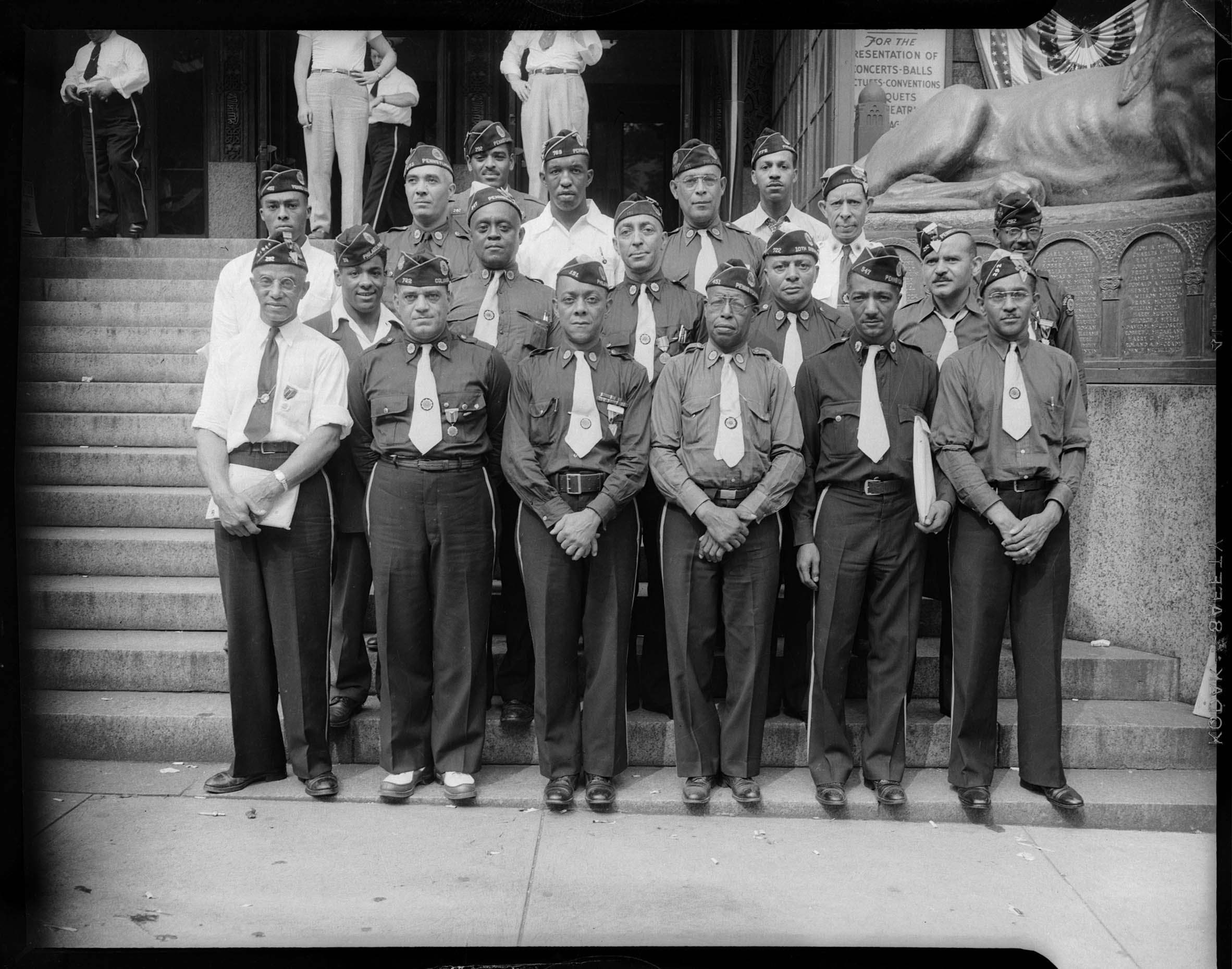 Group portrait of men wearing VFW uniforms from various posts including