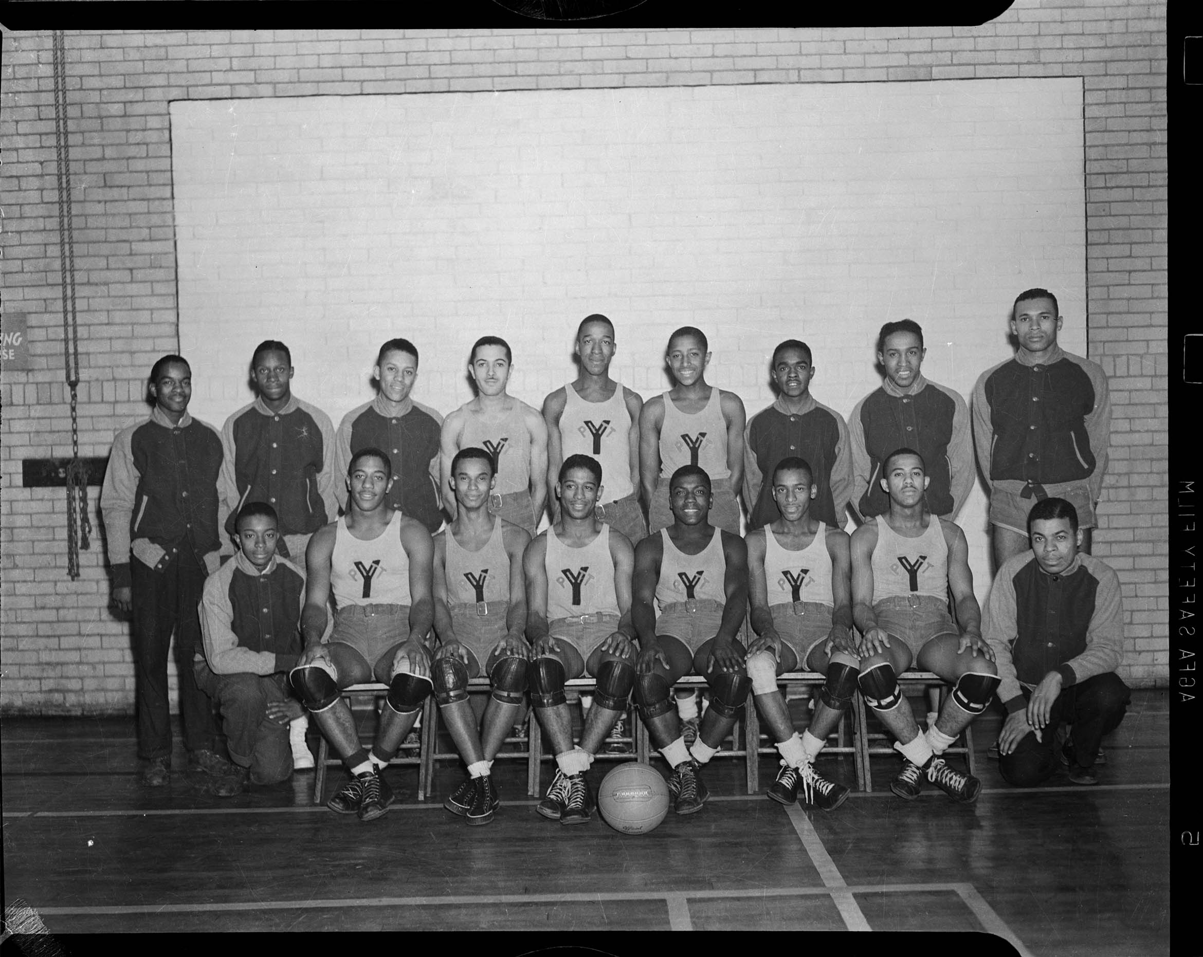 Group portrait of Centre Avenue YMCA Big Five basketball team, front row from left assistant
