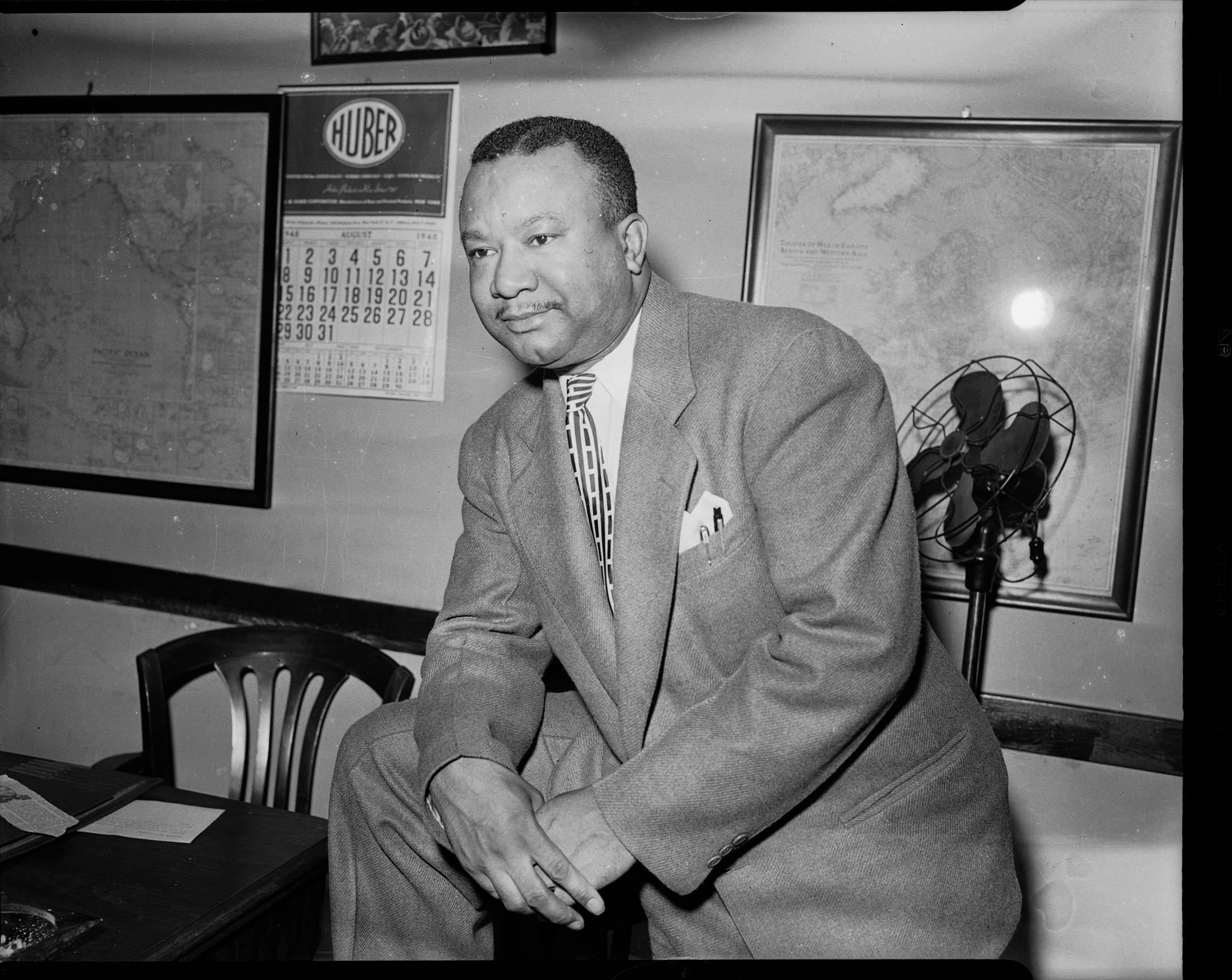 Portrait of man wearing suit with two pens in breast pocket, and