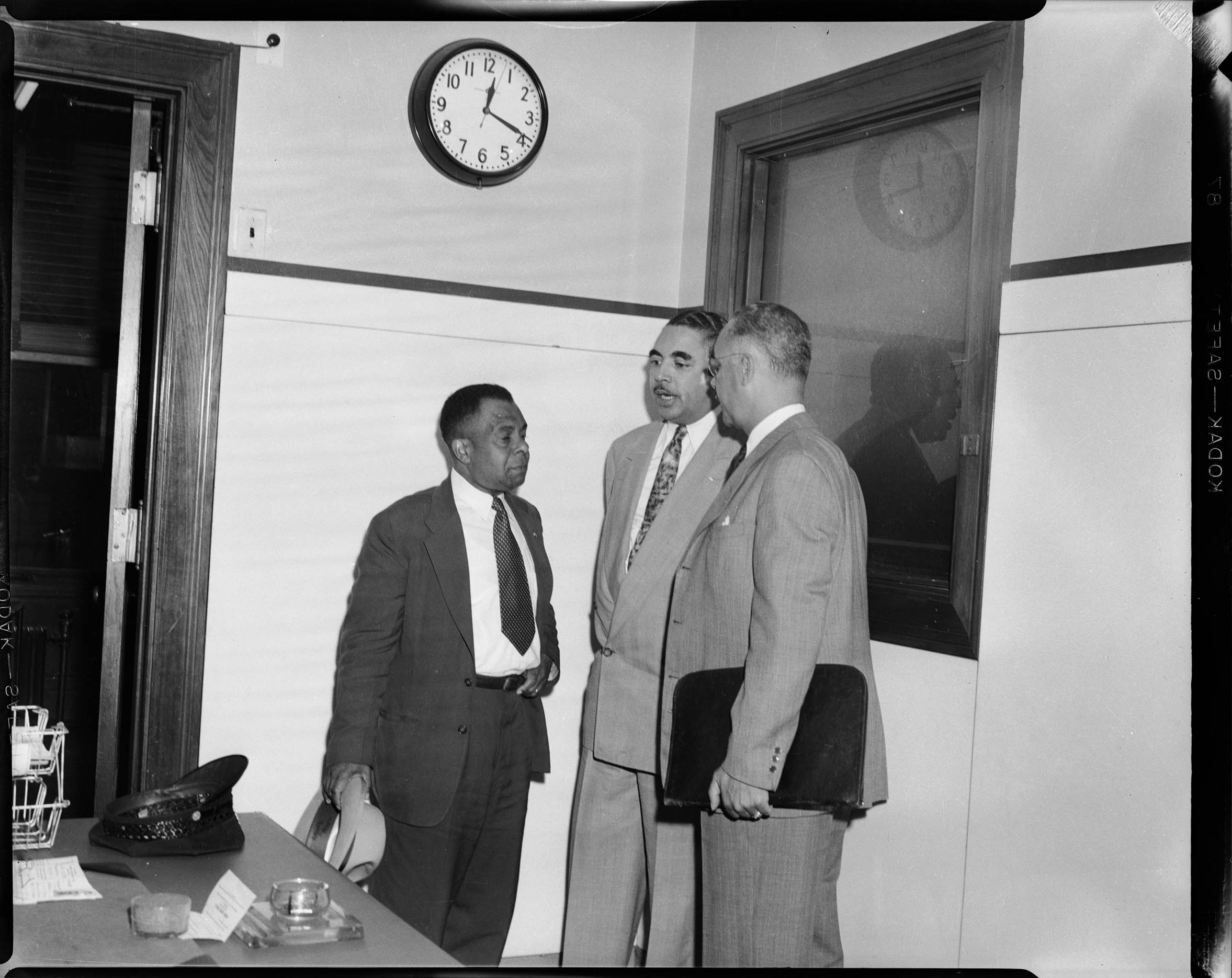 Dr. Reginald Dixon, center, and his attorneys Richard F. Jones, right