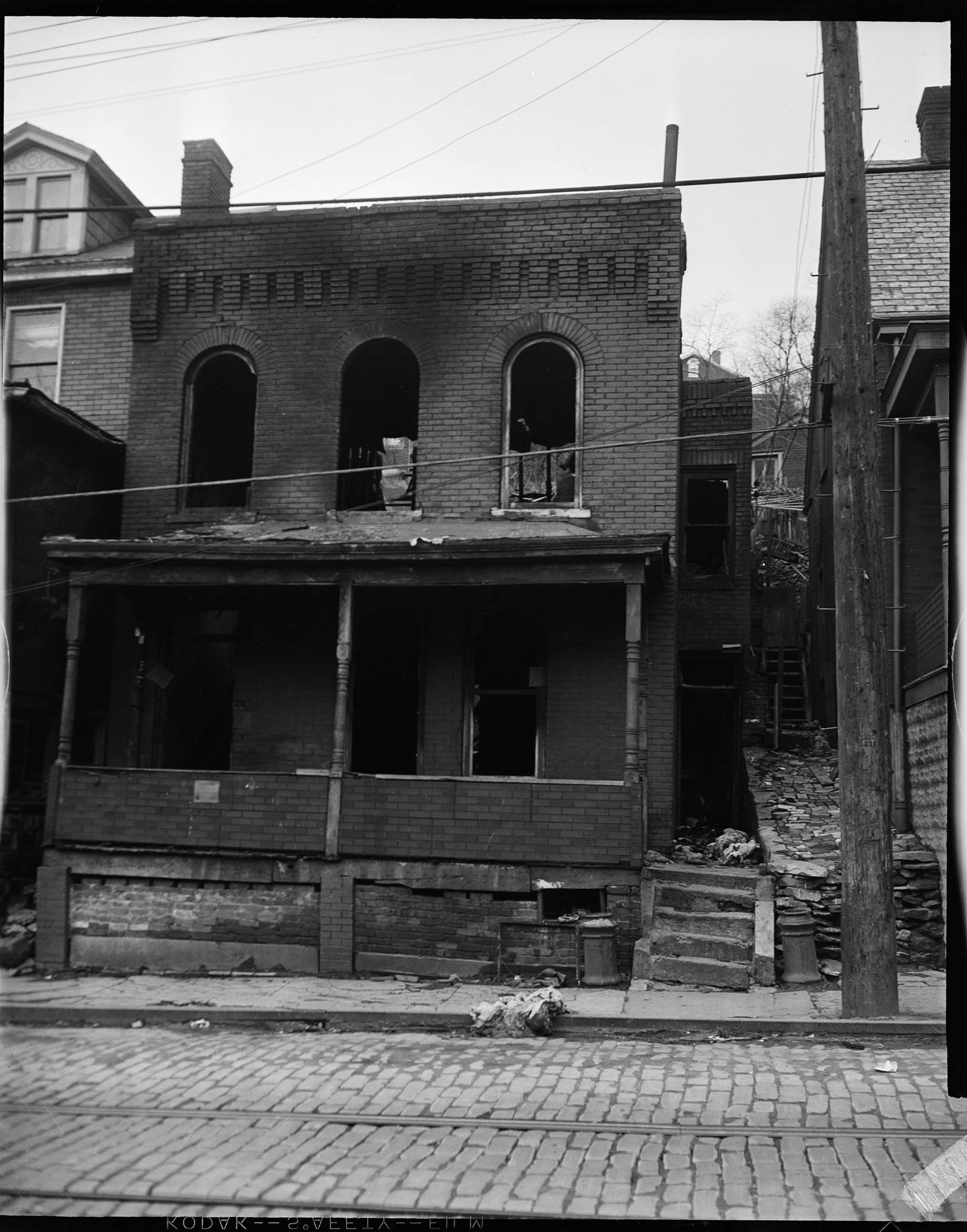 Exterior Of A Brick Building With Fire Or Water Damage Front Porch
