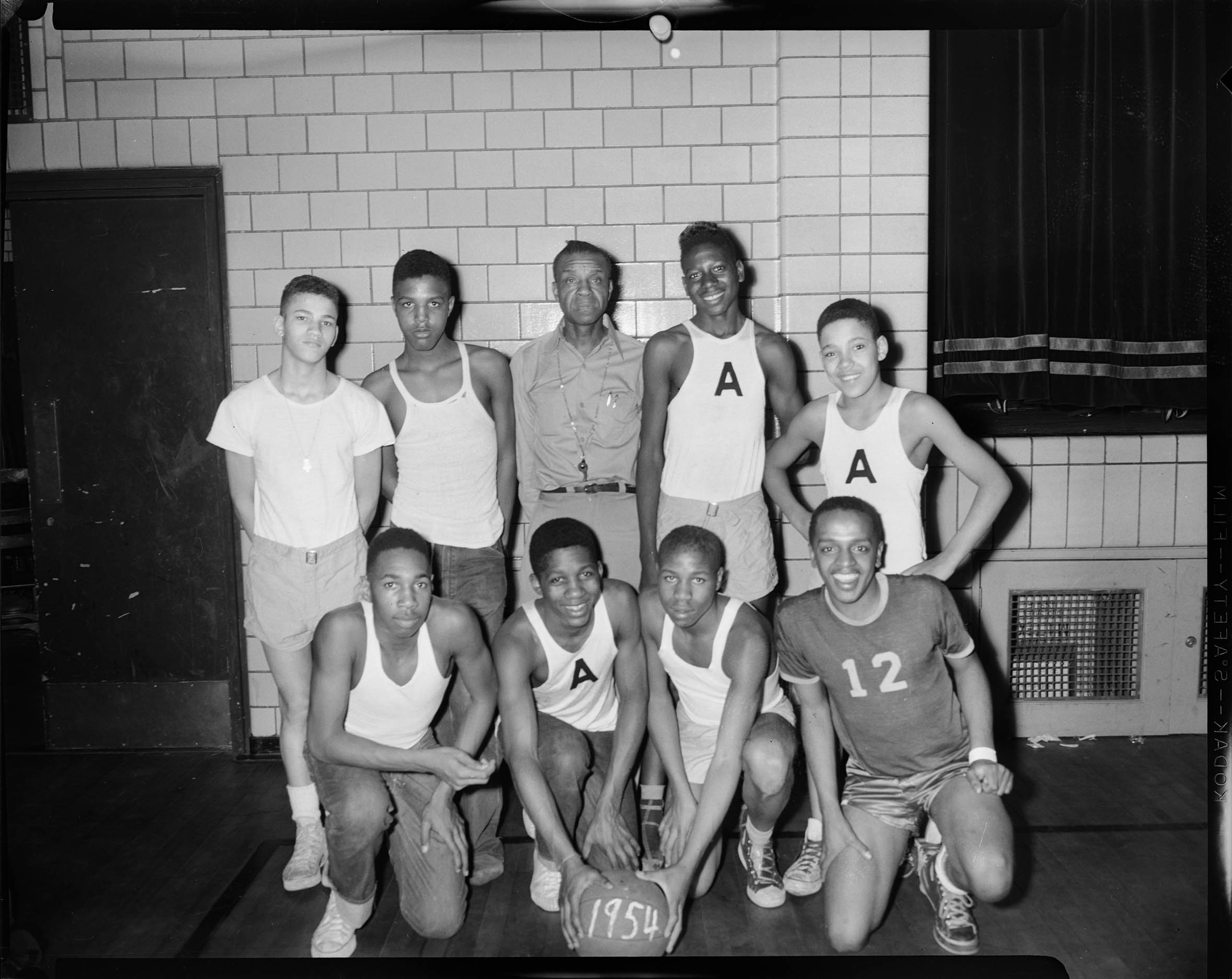 Group portrait of Ammon Center Junior basketball team, front row from