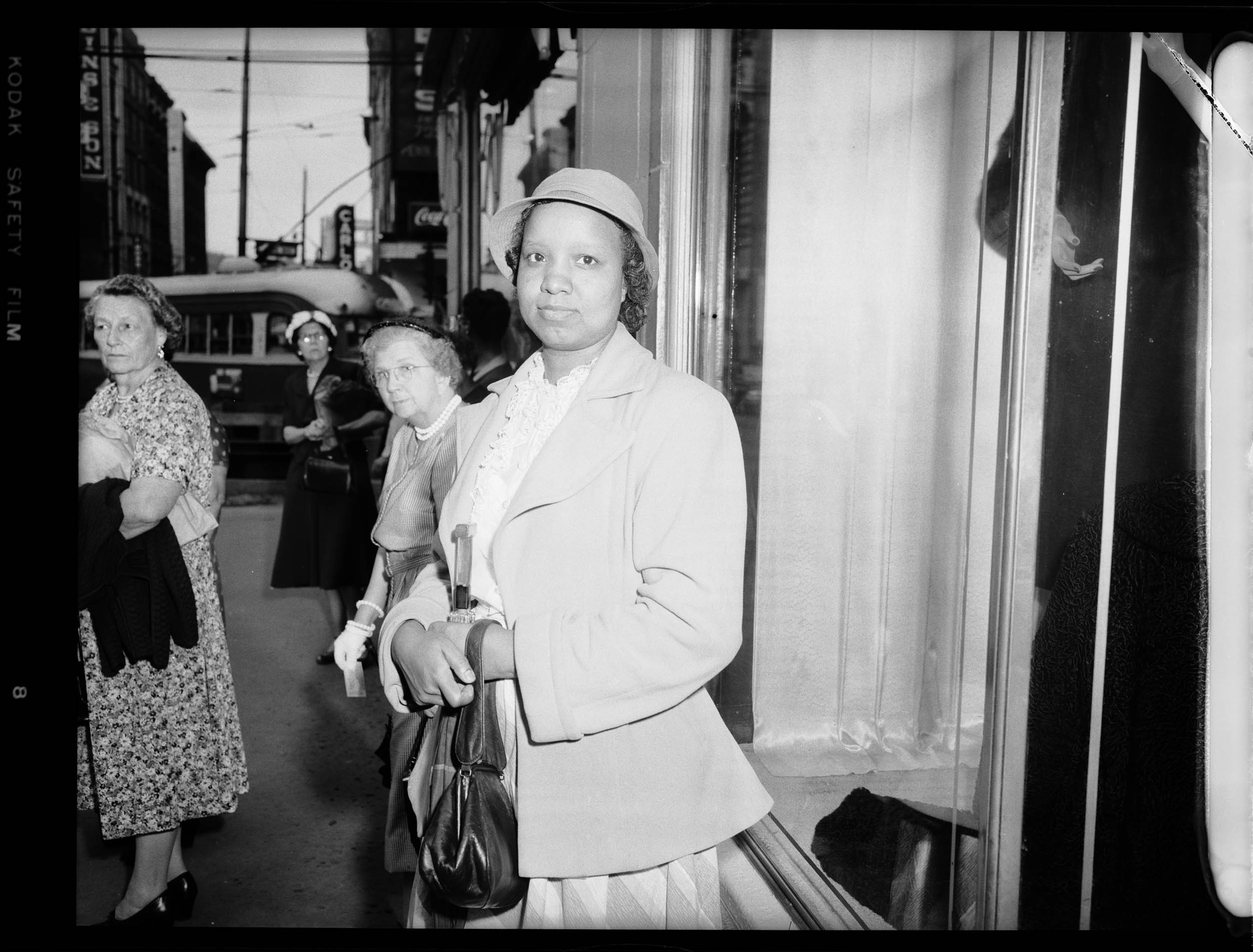 Portrait of Mildred Johnson wearing hat, light colored ruffled blouse, light colored jacket, and