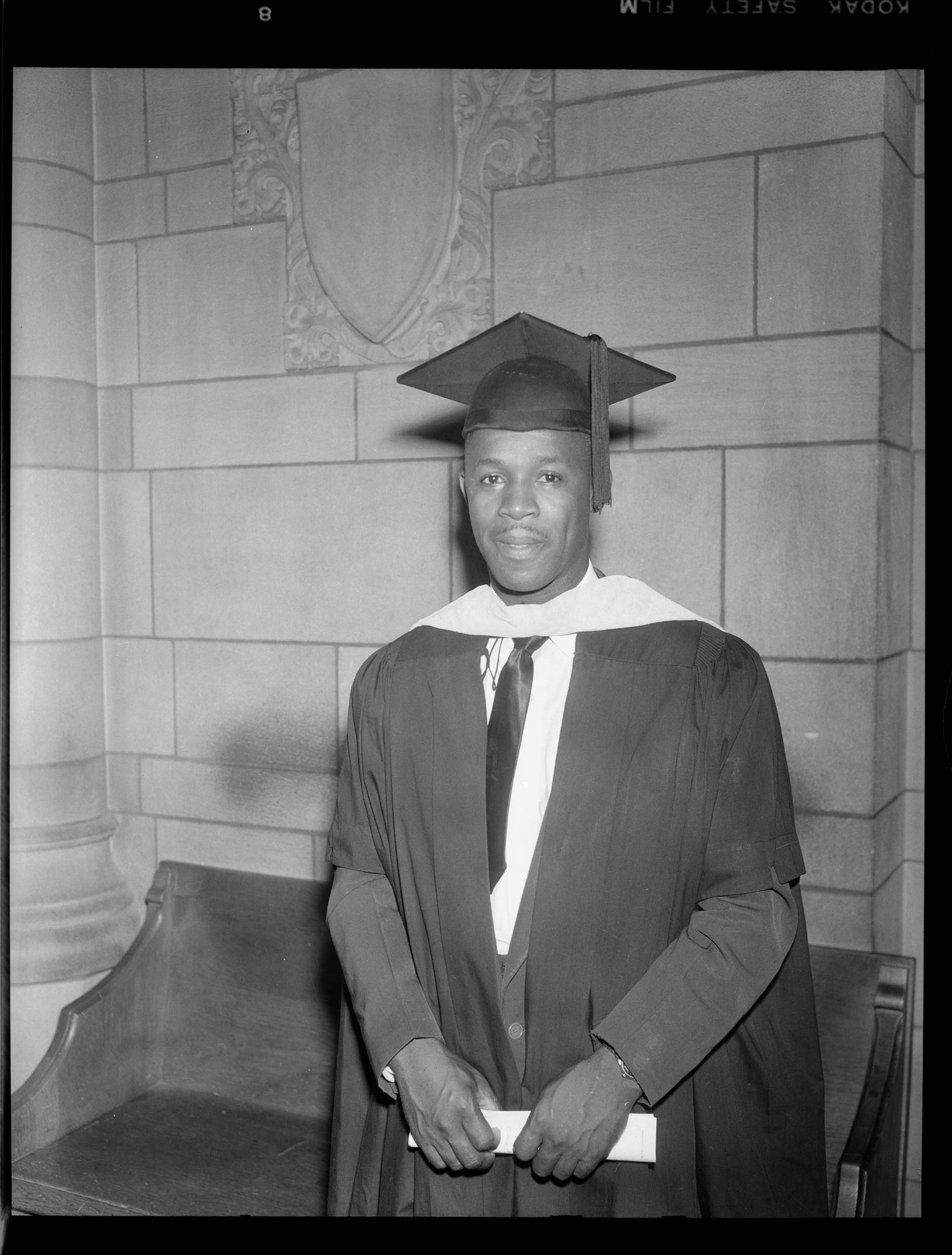 Portrait of Eldridge M. Hunter wearing dark cap and gown and light