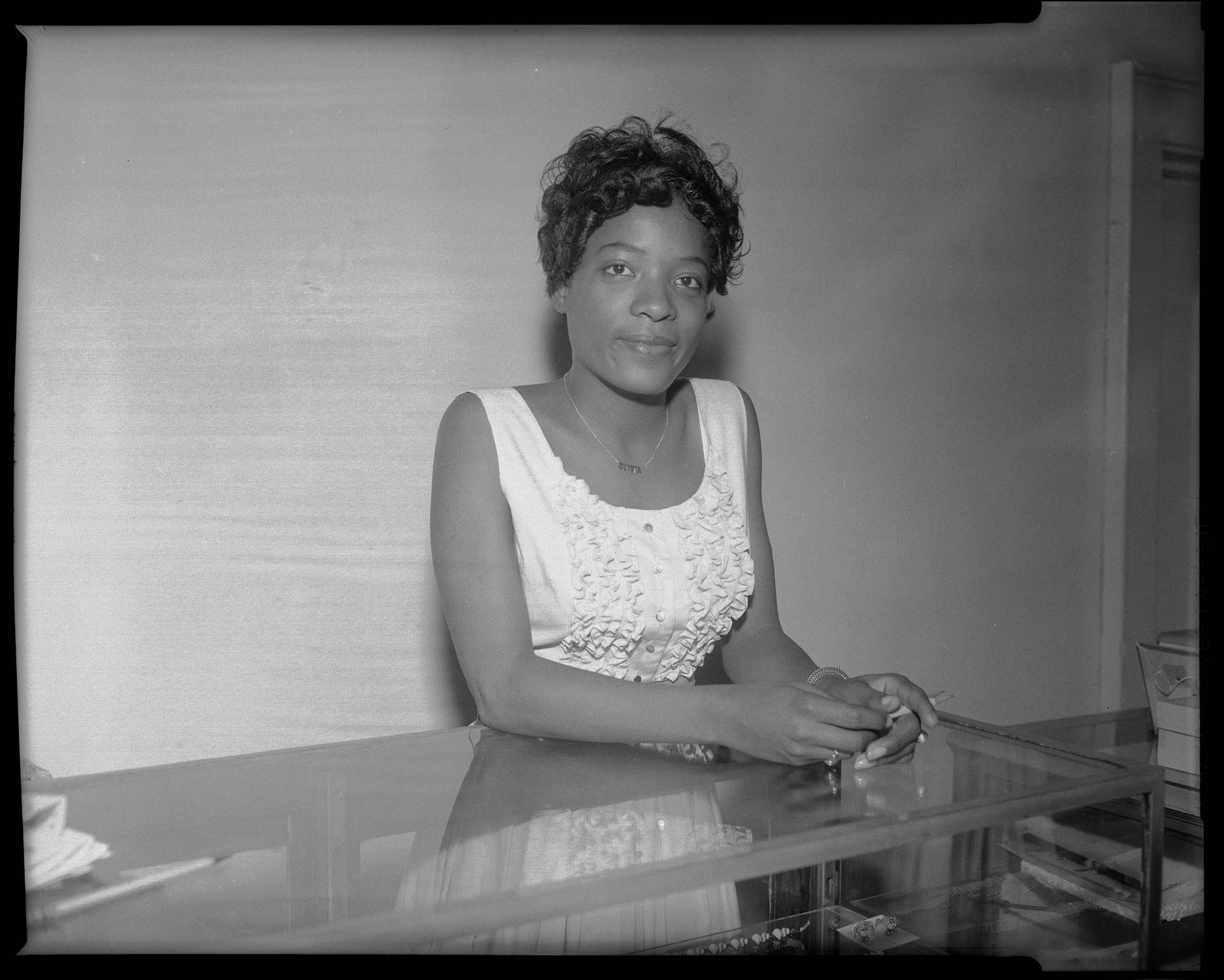 Portrait Of Woman Wearing Necklace That Reads Olivia And Light 