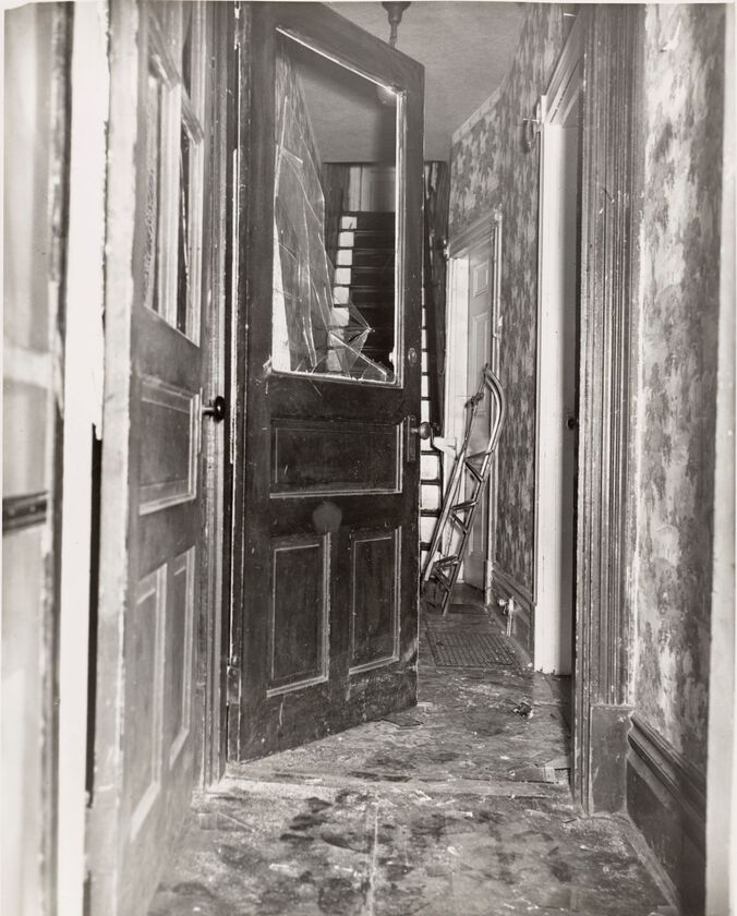Interior Entryway Of House With Floral Wallpaper And Broken Front Door Window With Sled In 